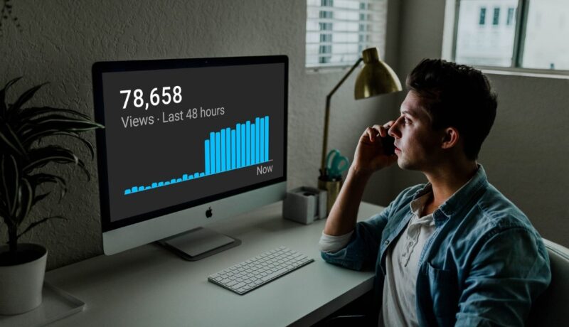 Man looking at YouTube analytics on his PC