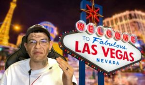 A man gazes at the iconic Las Vegas sign, bathed in the vibrant glow of the city lights