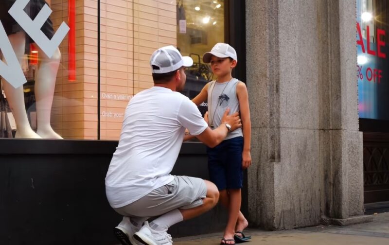 Dad hugs his son on a street