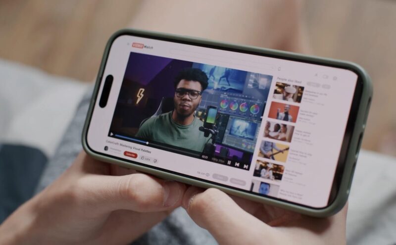 Person watching YouTube content on a phone