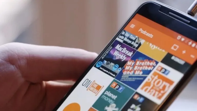 A Person Holding a Smartphone with A Podcast App Open, Showing Various Podcast Covers, Highlighting Options for Free Podcast Apps