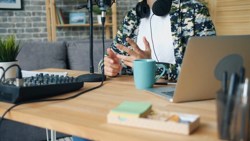 A man speaking into a microphone during a podcast