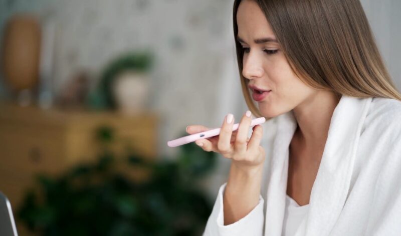 Woman using voice search feature on a smartphone