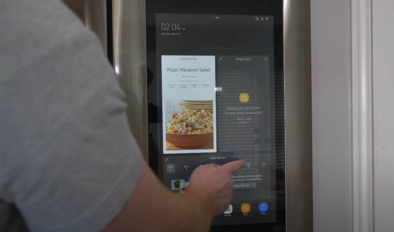 A smart refrigerator's touchscreen displays a recipe