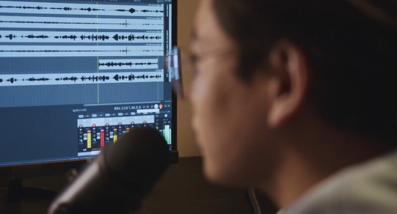 Close-up view of a person immersed in the world of audio production