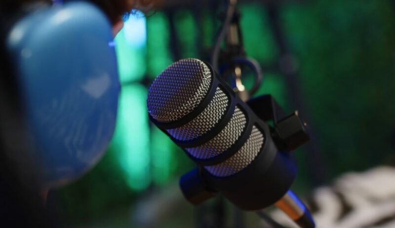 A microphone in a vibrant green studio