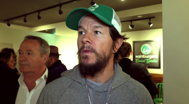 Mark Whalberg gives in interview, wearing green cap