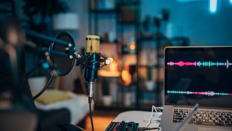 Podcast setup with mic and laptop, showing the rise of money and lifestyle podcasts