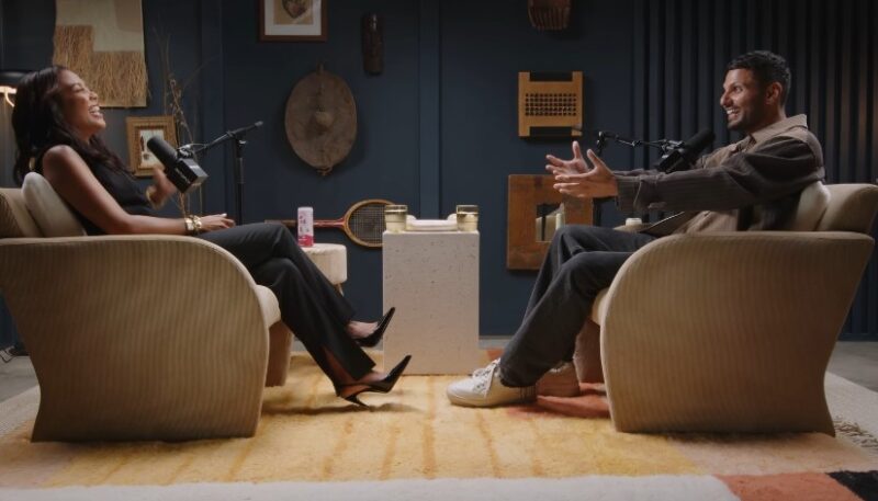 Two individuals on a podcast having a laugh during discussion