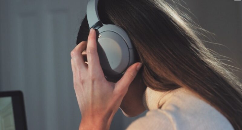 Woman listening a podcast on her headphones