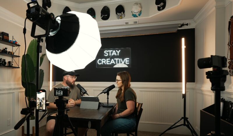 A vibrant podcast studio, bathed in soft light, fosters creative conversation