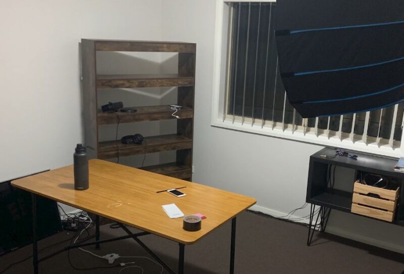 A workspace, meticulously arranged, with a backdrop ready for creative expression