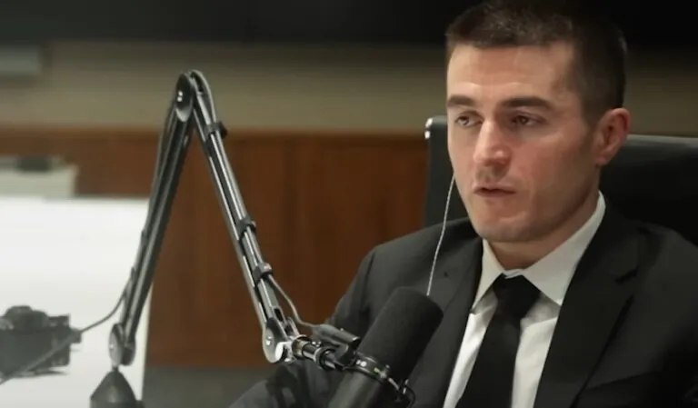 Lex Fridman talking during a podcast, wearing glasses